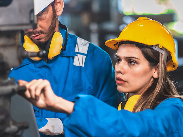 women and man with yellow helmet working at zehnder 